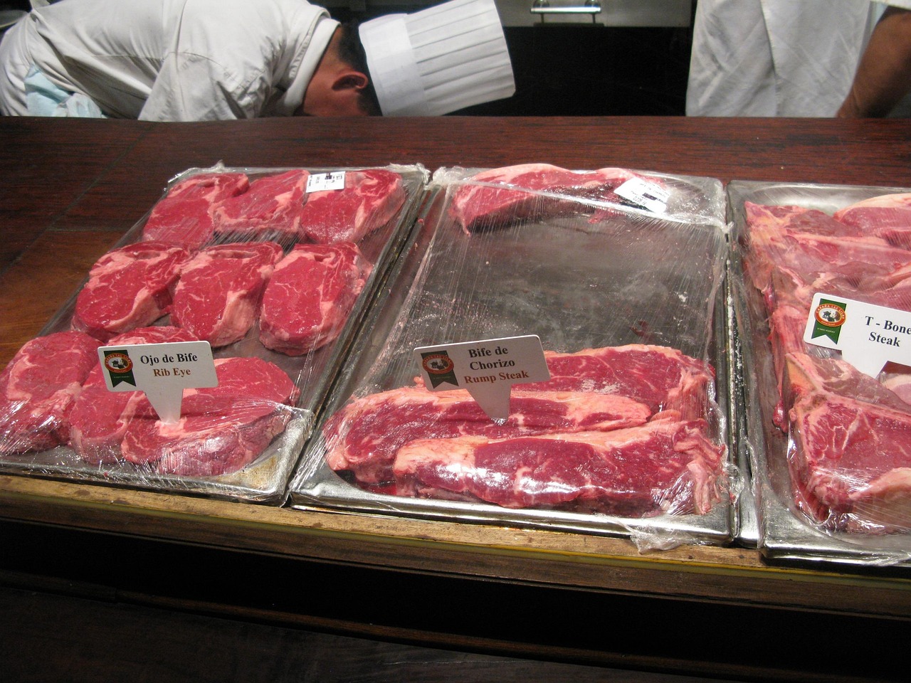 Carne cruda estratta dal frigo, evidenziando l'importanza di una corretta conservazione.